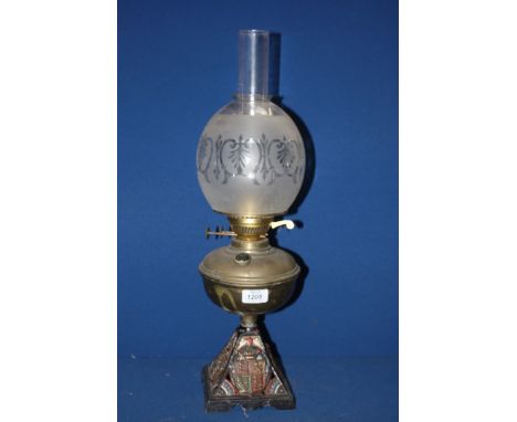 An Oil Lamp with heraldic decoration to base and frosted glass shade, a/f