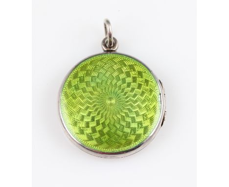 A white metal green guilloche enamel locket pendant, metal indistinctly marked, diameter approx. 3cm.