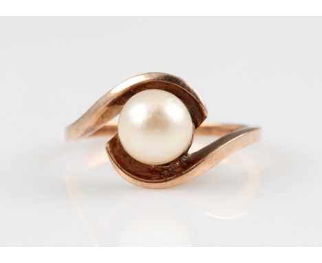 A pearl ring, of cross over design, indistinctly stamped, ring size L½, weight approx. 2.9g.