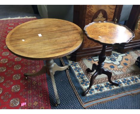 A mahogany drop leaf dining table together with two mahogany single columned wine tables.