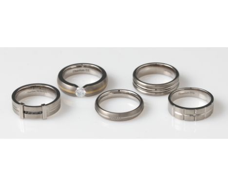 A collection five titanium rings, two set with colourless diamonds and another set with black diamonds, one set with a CZ, (5