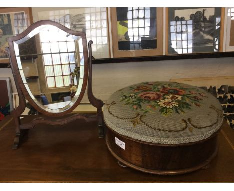 A 19th century walnut foot stool with tapestry top. Together with a small shield shaped swing mirror.