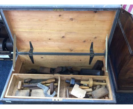 A pine box containing various tools.