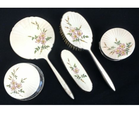 An enamel and silver dressing table set, comprising of a mirror, hair brush, hand brush and two lidded trinket pots, all deco