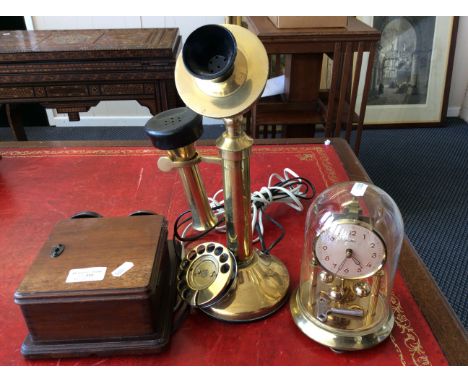 A brass G.E.C. stick phone with a mahogany bell box and a brass finished Bentima clock.