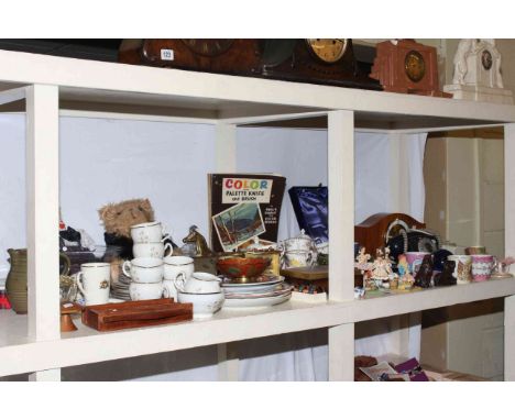 Shelf of ceramics, glass, mantel clock, napkin rings, vintage telephone, thimbles.