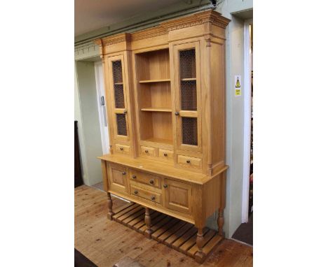 Light oak kitchen dresser, the inverted breakfront top having centre shelves flanked by cupboards above four spice drawers, t