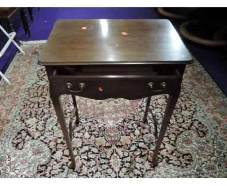 An early 20th Century mahogany side table with fitted compartmental frieze drawer, cross stretcher missing