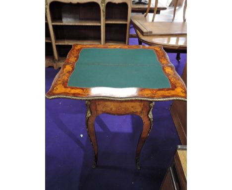 An early 20th Century continental style inlaid fold over card table, with ormolu effect detailing, serpentine fron , width ap