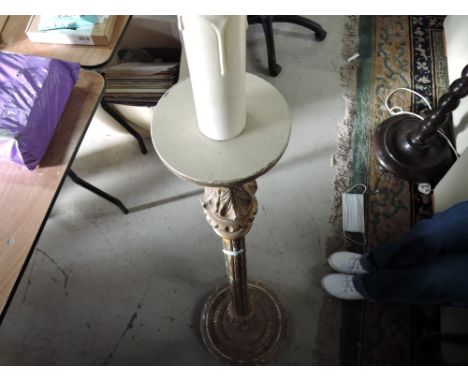 A gilt effect wooden standard lamp in the classical style