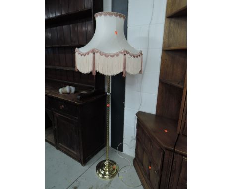A modern brass standard lamp