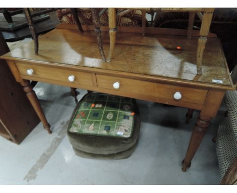 A traditional pine side table having ledge back, turned legs and ceramic drawer handles to the two frieze drawers, approx. di