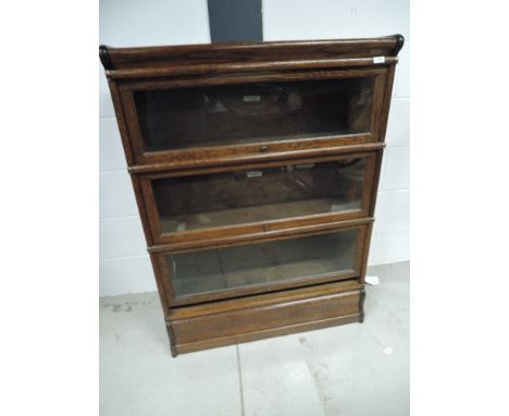 An early 20th Century oak three tier stacking bookcase, bearing labels for Globe-Wernicke