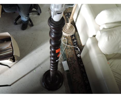 A traditional oak standard lamp having turned frame