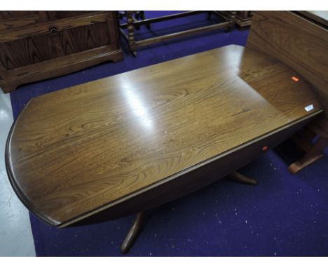 An Ercol mid stained drop leaf coffee table, width approx. 121cm