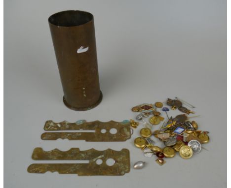Collection of military badges and buttons together with brass shell and button cleaning guard 