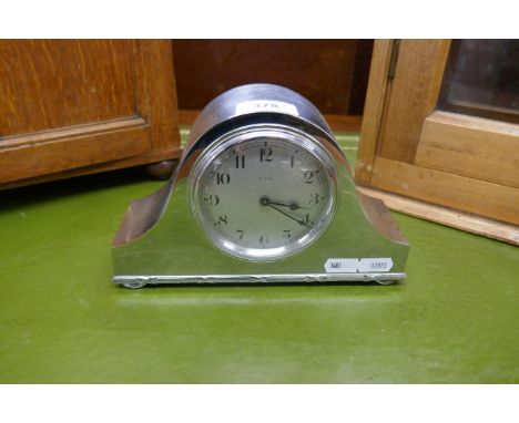 Silverplated 'Napoleon Hat' style mantel clock circa 1930 with white dial and Arabic numbers. A French 8 day Bayard lever mov