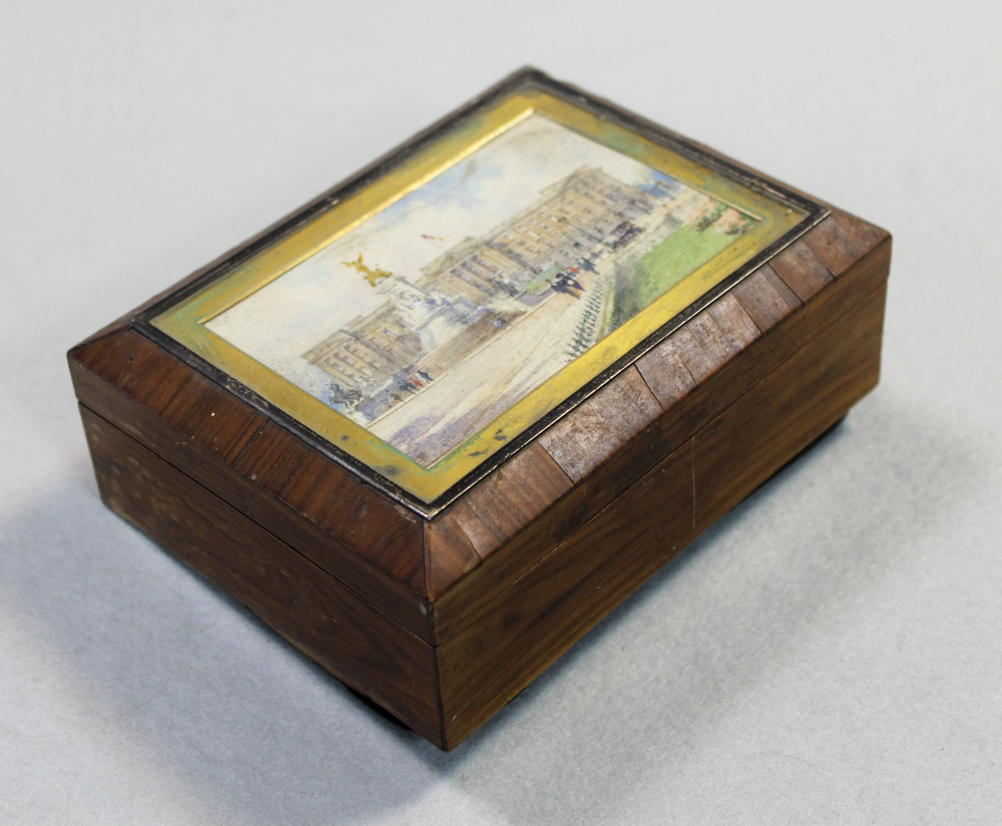 An early 20th century cigarette box, the lid painted with Buckingham