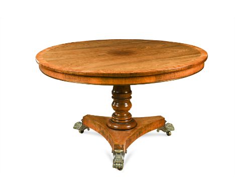 the circular folding top with cross banded edge, the turned baluster support on a trefoil plinth base with gilt brass hairy l