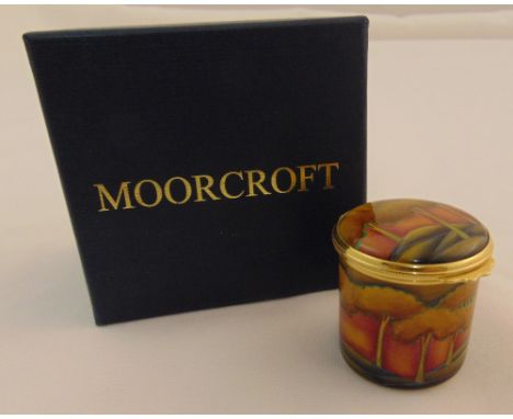 Moorcroft enamel circular hinged box decorated with a sunset forest, marks to the base, in original packaging, 4cm (h)