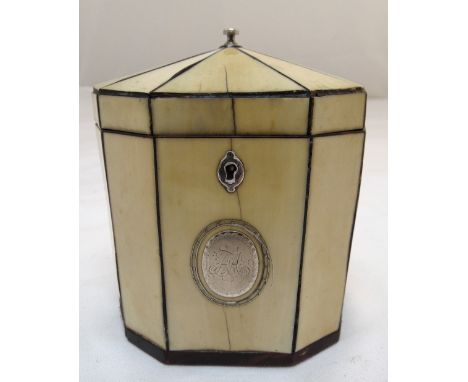 A George III octagonal tea caddy with applied silver cartouche, escutcheon and finial to hinged cover, 12 x 11 x 7cm