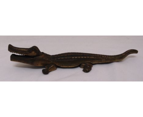 A brass nutcracker in the form of a crocodile, 36cm (w)