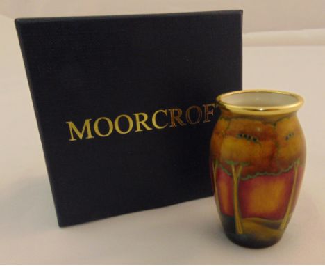 Moorcroft enamel miniature vase decorated with a sunset forest, marks to the base, in original packaging, 6cm (h)