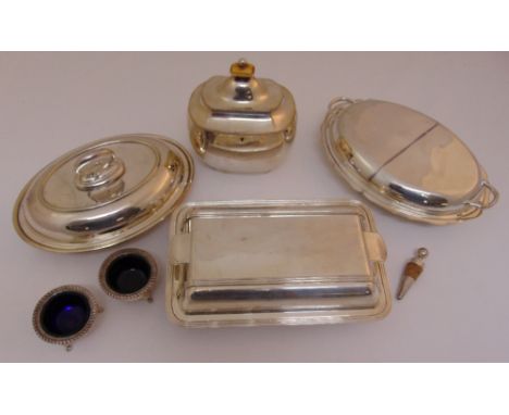 A quantity of silver plate to include entrée dishes and covers, a tea caddy and two salts with blue glass liners