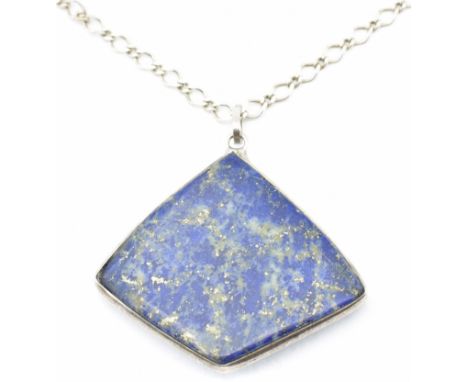 A 925 silver and lapis lazuli pendant necklace. The necklace strung with a large diamond shaped lapis lazuli plaque strung on