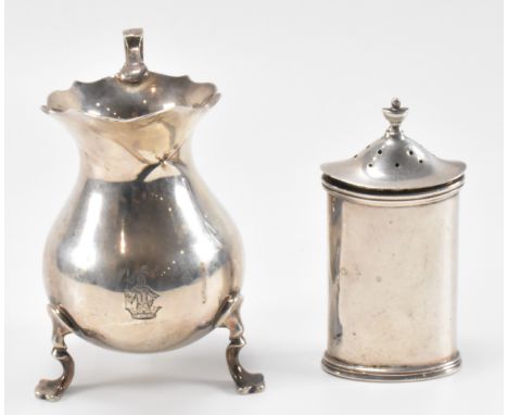 A silver hallmarked 19th Century Victorian creamer jug having a moulded rim and scrolled handle raised on three feet, togethe