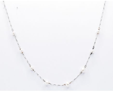 An early 20th Century platinum and pearl necklace chain. The necklace having fine elongated links threaded with eight pearls.