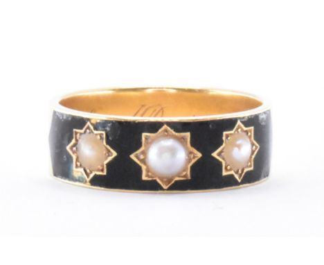 A hallmarked 18ct gold mourning band ring.The ring having four star set half pearls mounted within a black enamel cartouche. 