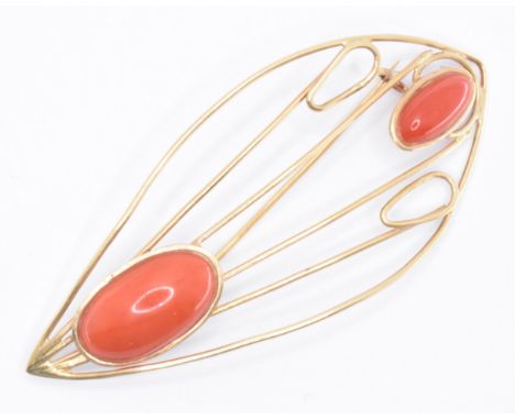 A vintage 18ct gold and coral brooch pin. The brooch of leaf form having open work detailing and set with two coral precious 