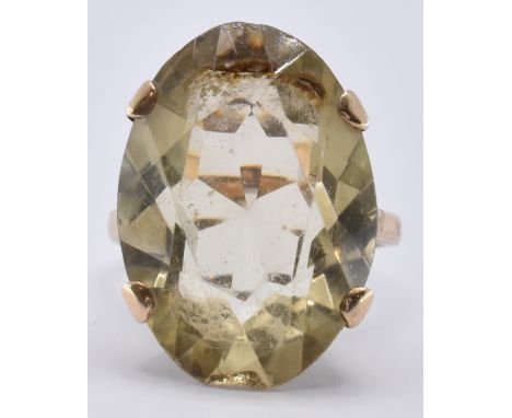 A hallmarked 9ct gold and citrine ring being set with an oval cut citrine in a scrolled mount. Citrine measures 2.4 x 1.7 x 0