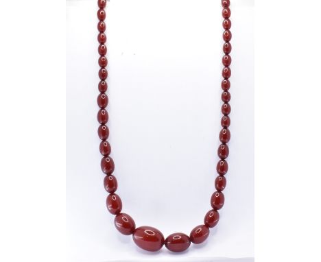 A vintage cherry bakelite beaded necklace. The necklace strung with 51 graduating oval beads. Weight 63.6g. Measures 27 inche