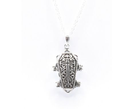 A silver gothic pendant necklace having an engraved coffin with an articulating skeleton within, strung&nbsp; upon a chain ne