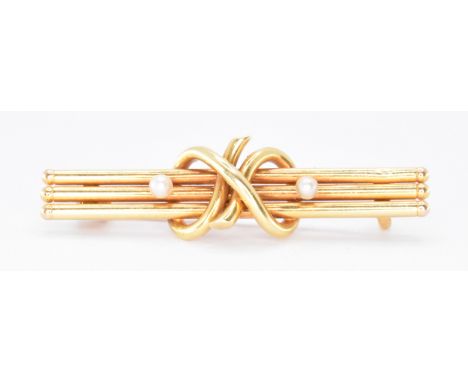 A vintage 15ct gold and pearl bar brooch. The brooch having three bars with a knot design to the centre flanked by two pearls