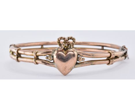 A 19th Century Victorian bangle bracelet having a heart motif to the centre with knot design to the top, having a hinged open