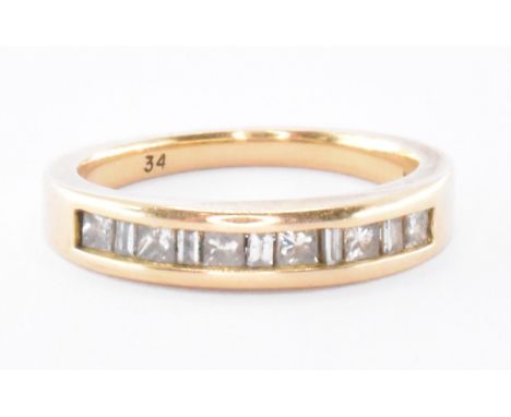 An 18ct gold and diamond ring being channel set with square and rectangular cut diamonds. Assay marked Birmingham 750. Weight