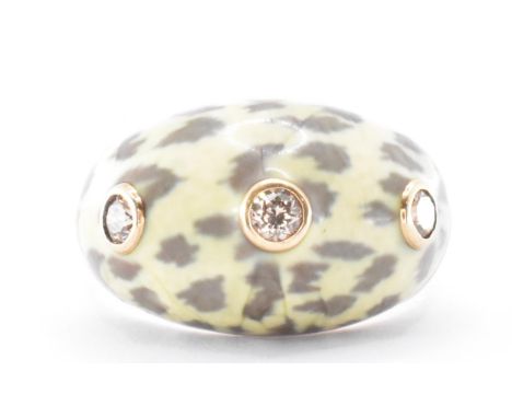 A 14ct gold diamond and enamel dome ring. The ring having three bezel set round cut diamonds within an enamelled leopard prin