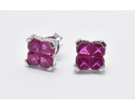 A pair of 9ct white gold and ruby stud earrings. The earrings with 4 round cut ruby stones to each set to white gold mounts a