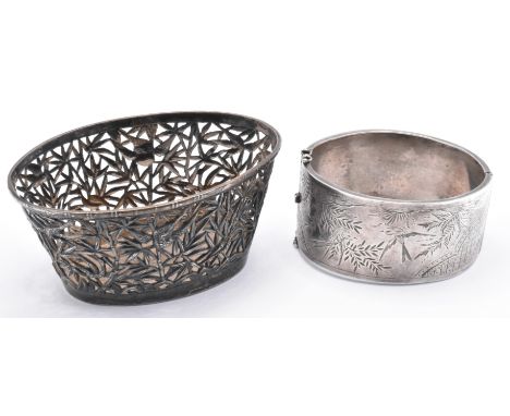 A Chinese silver basket / pot of small proportions being oval shaped with pierced bamboo and bird decoration to the sides, to