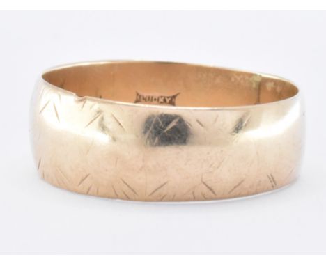 A hallmarked 9ct gold band ring of wide D shape. Hallmarked London 1975. Weight 4.9g. Size X.5.