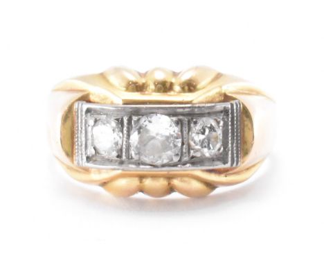 An 18ct gold and diamond three stone ring. The ring set with three round cut graduating diamonds to the head with reeded deta