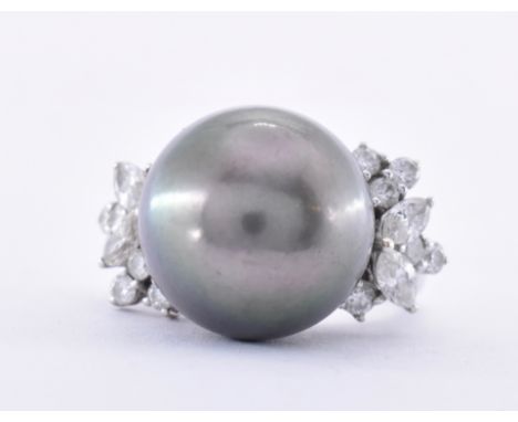 An 18ct white gold Tahitian pearl and diamond cocktail ring. The ring set with a central Tahitian pearl approx 14mm flanked b