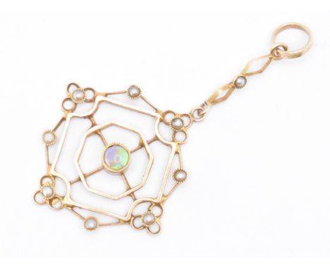 An early 20th Century Edwardian 15ct gold opal and pearl pendant. The pendant having an open work drop set with a central rou