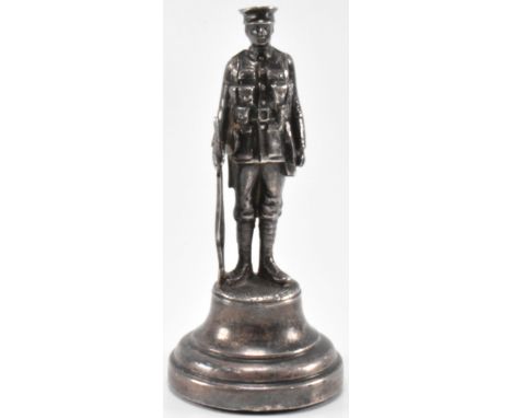 A WWI first world war period silver hallmarked soldier figurine. The figurine depicting a solider in battle dress raised on a