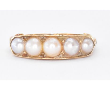 An 18ct gold and pearl half hoop ring. The ring set with five graduating pearls of varying colour to scroll decorate gallery 