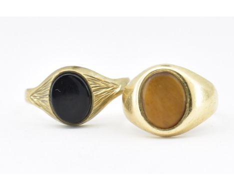 Two hallmarked 9ct gold signet rings. A signet ring set with a tiger's eye, hallmarked Birmingham Size K.5.&nbsp; A signet ri
