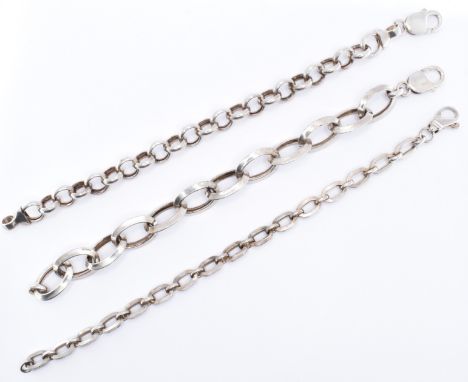 A group of three silver bracelets to include a belcher link chain with a lobster clasp, an oval link chain with a lobster cla